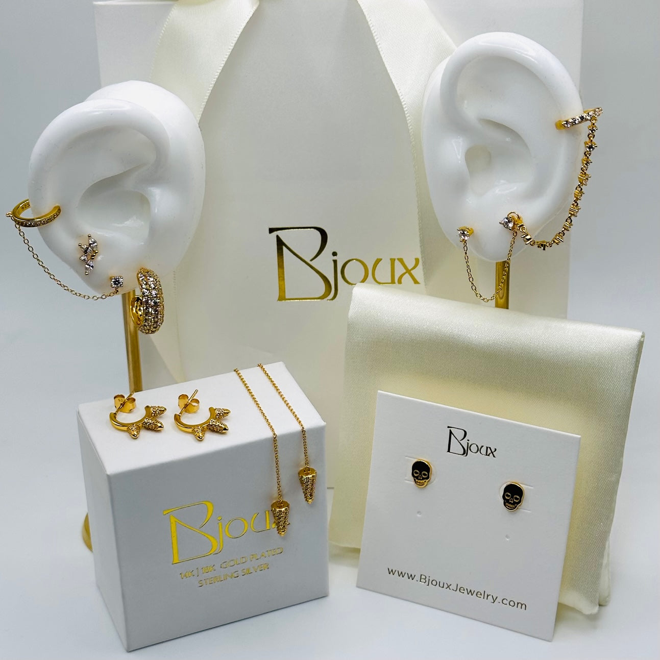 A display of beautiful sterling silver, 18k gold plated earrings. Trendy, elegant and timeless tyles allow these pieces to be worn in multiple ways.