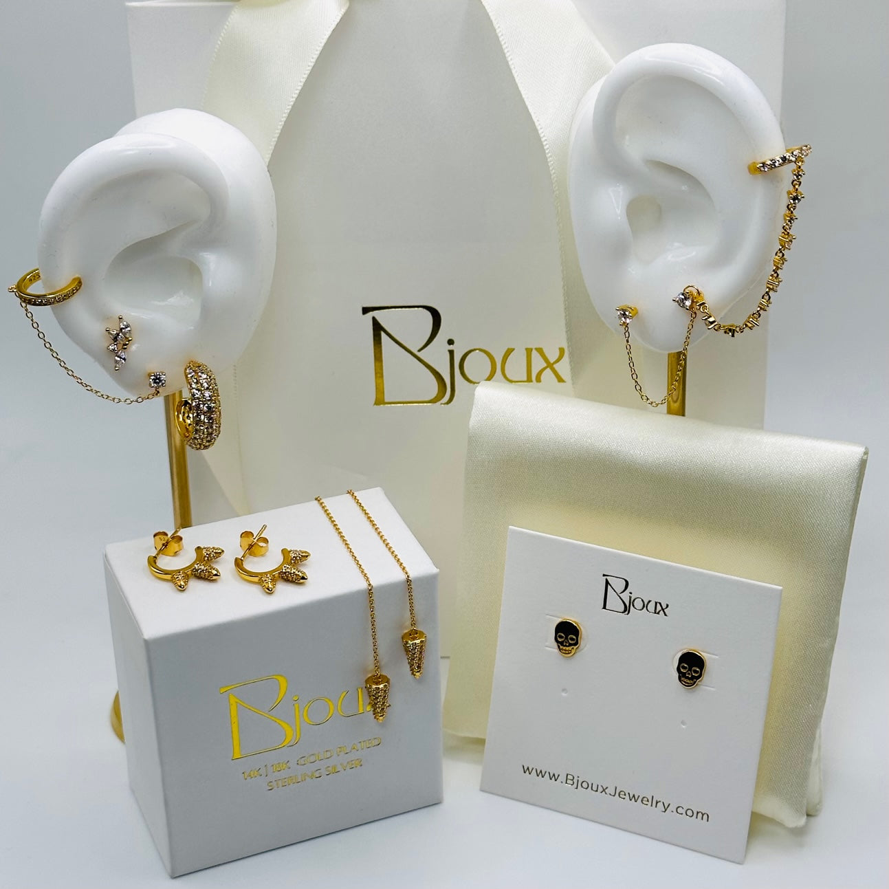 A display of beautiful sterling silver, 18k gold plated earrings.  Trendy, elegant and timeless tyles allow these pieces to be worn in multiple ways.